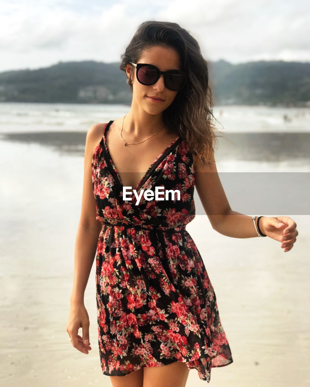 Portrait of beautiful young woman wearing sundress at beach