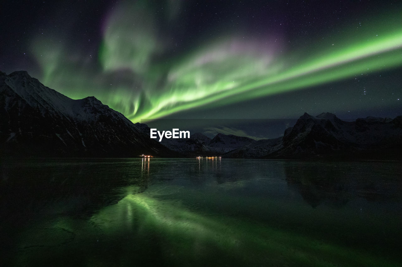 Scenic view of lake against sky at night