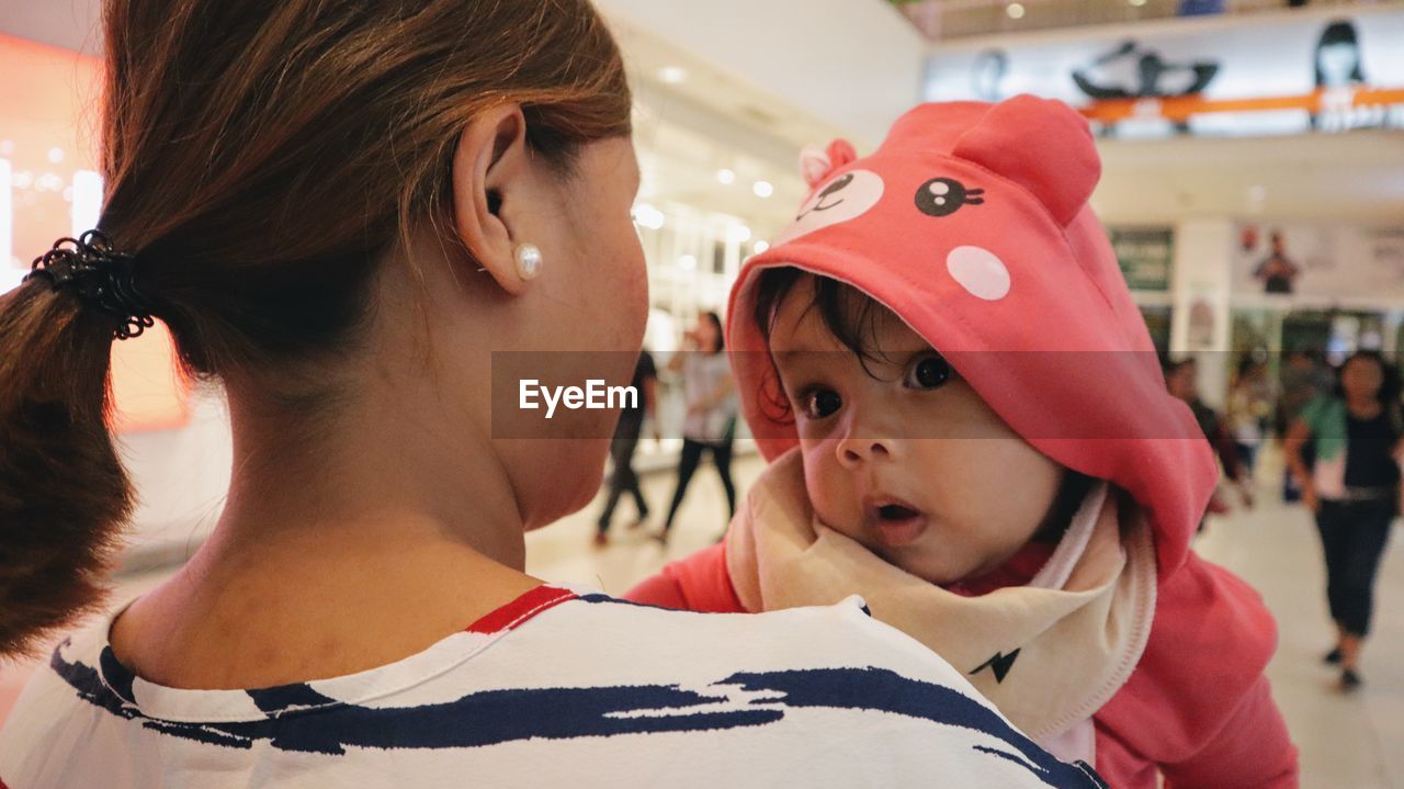 Close-up of mother and daughter in shopping mall