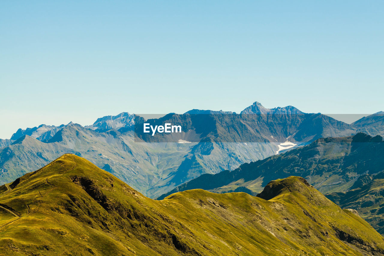 Scenic view of mountains against clear blue sky