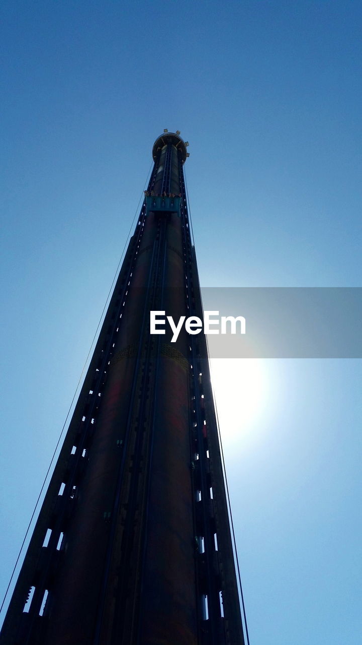 Low angle view of skyscraper against clear blue sky