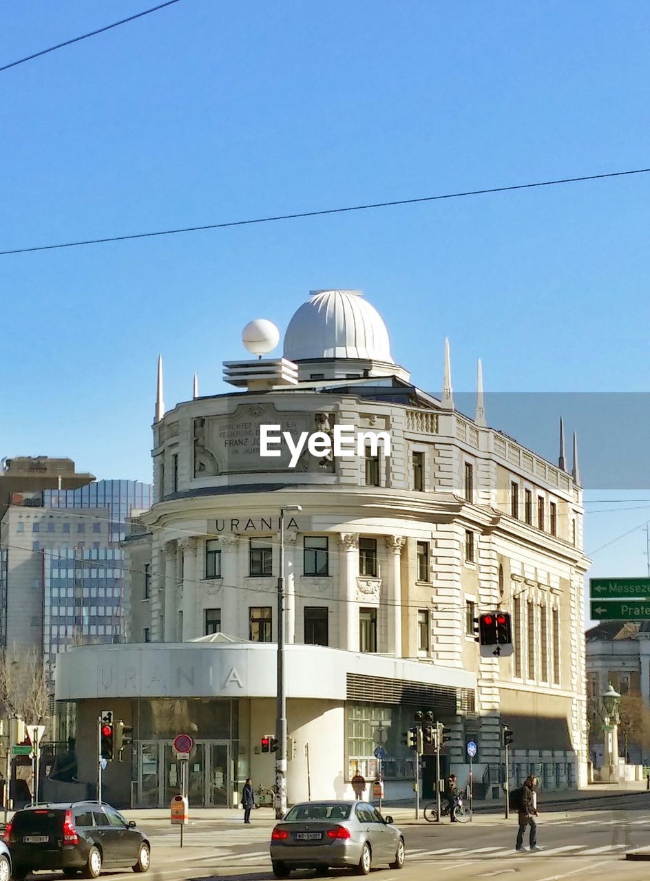 LOW ANGLE VIEW OF BUILDINGS AGAINST BLUE SKY