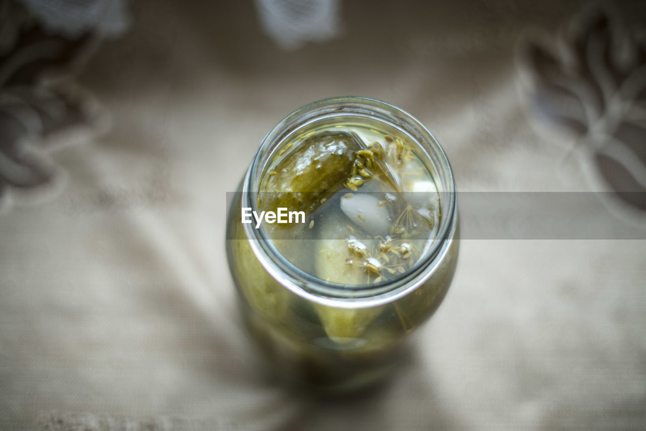 Close-up of cucumber pickle in jar on table