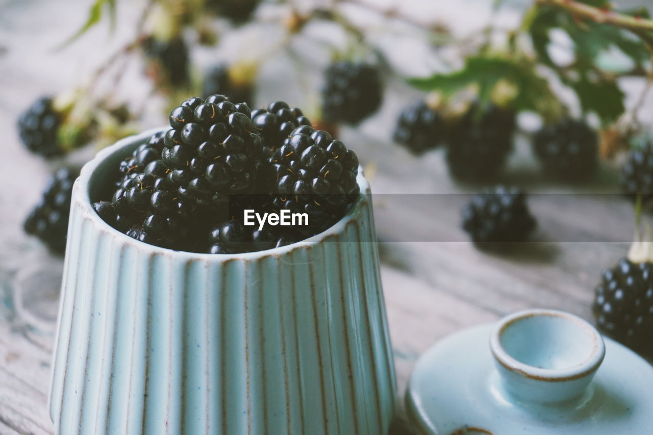 Close-up of blackberries in container on table