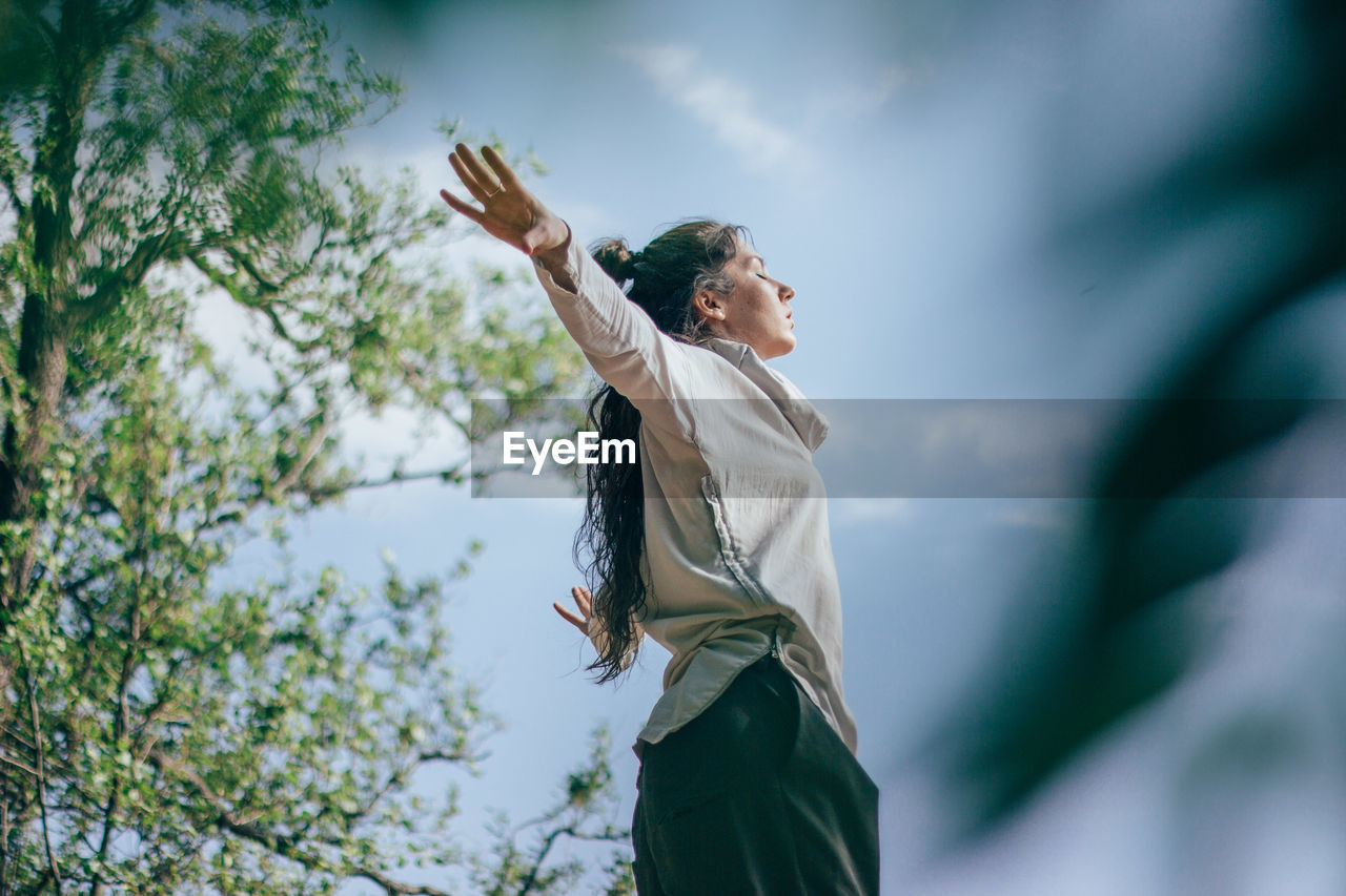 Woman dancing in forest