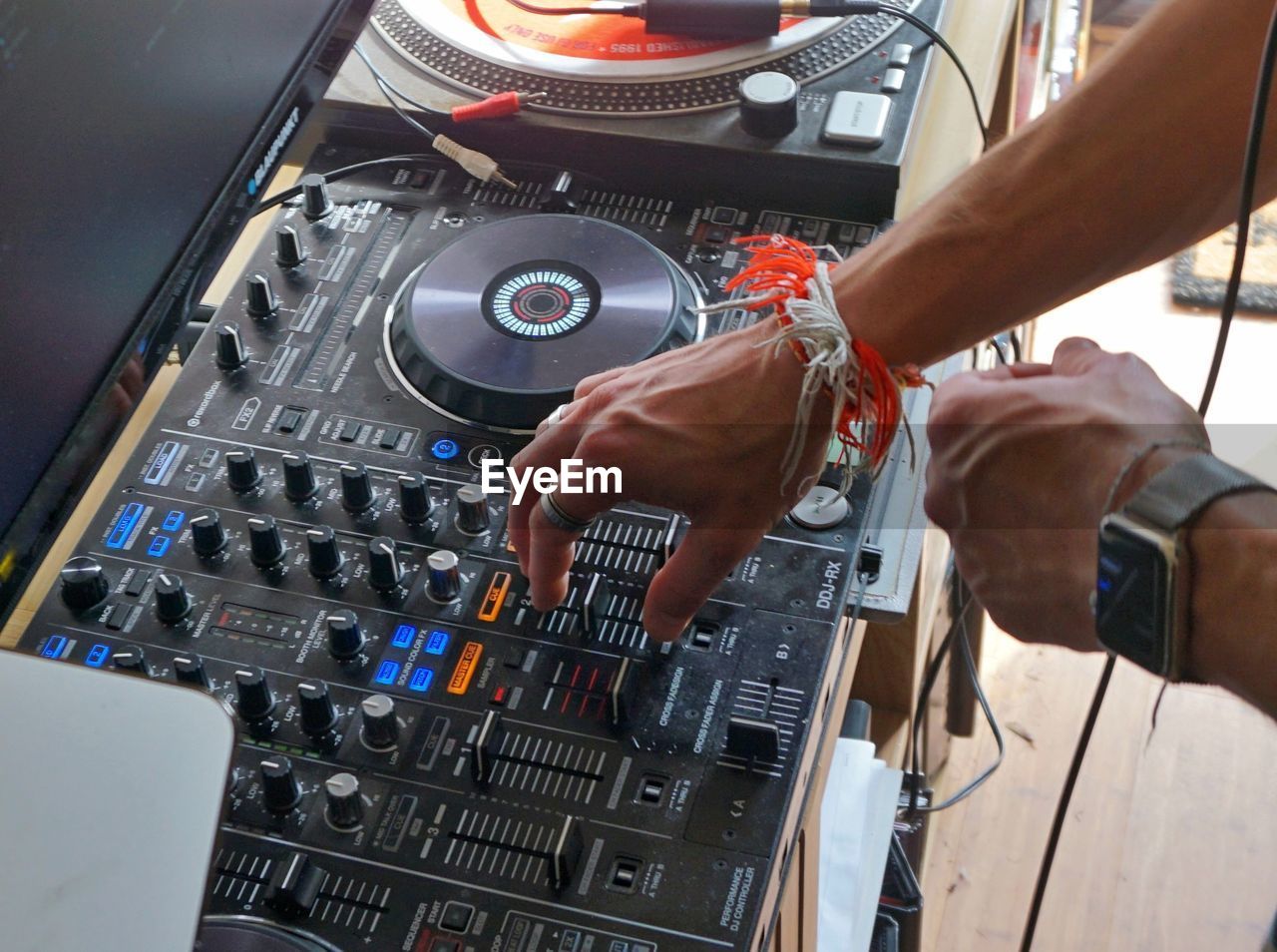 Cropped hands of man mixing sound at studio