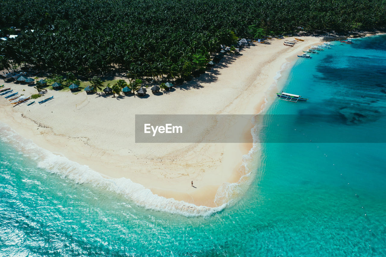 Drone view of man at beach on sunny day