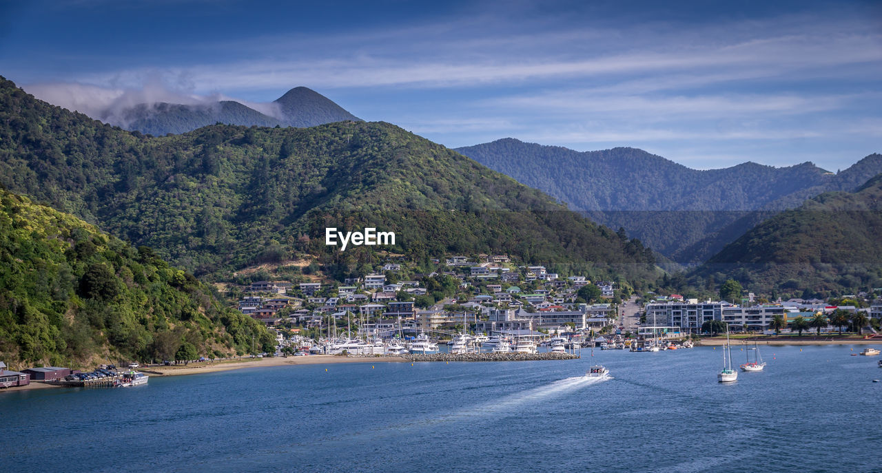 SCENIC VIEW OF CITY BY SEA AGAINST SKY