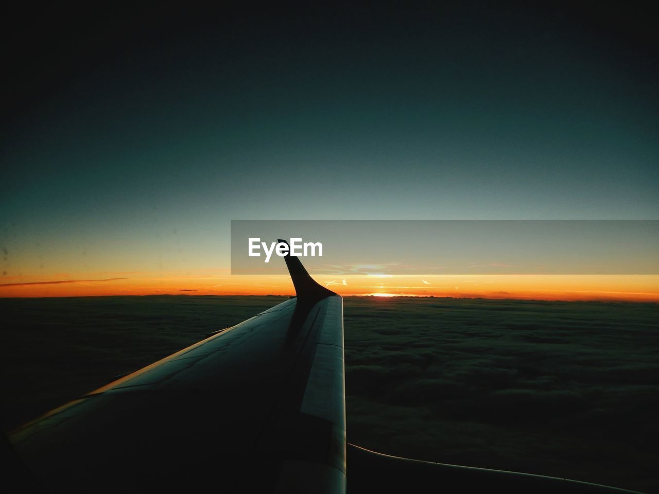 AIRPLANE WING AGAINST CLEAR SKY