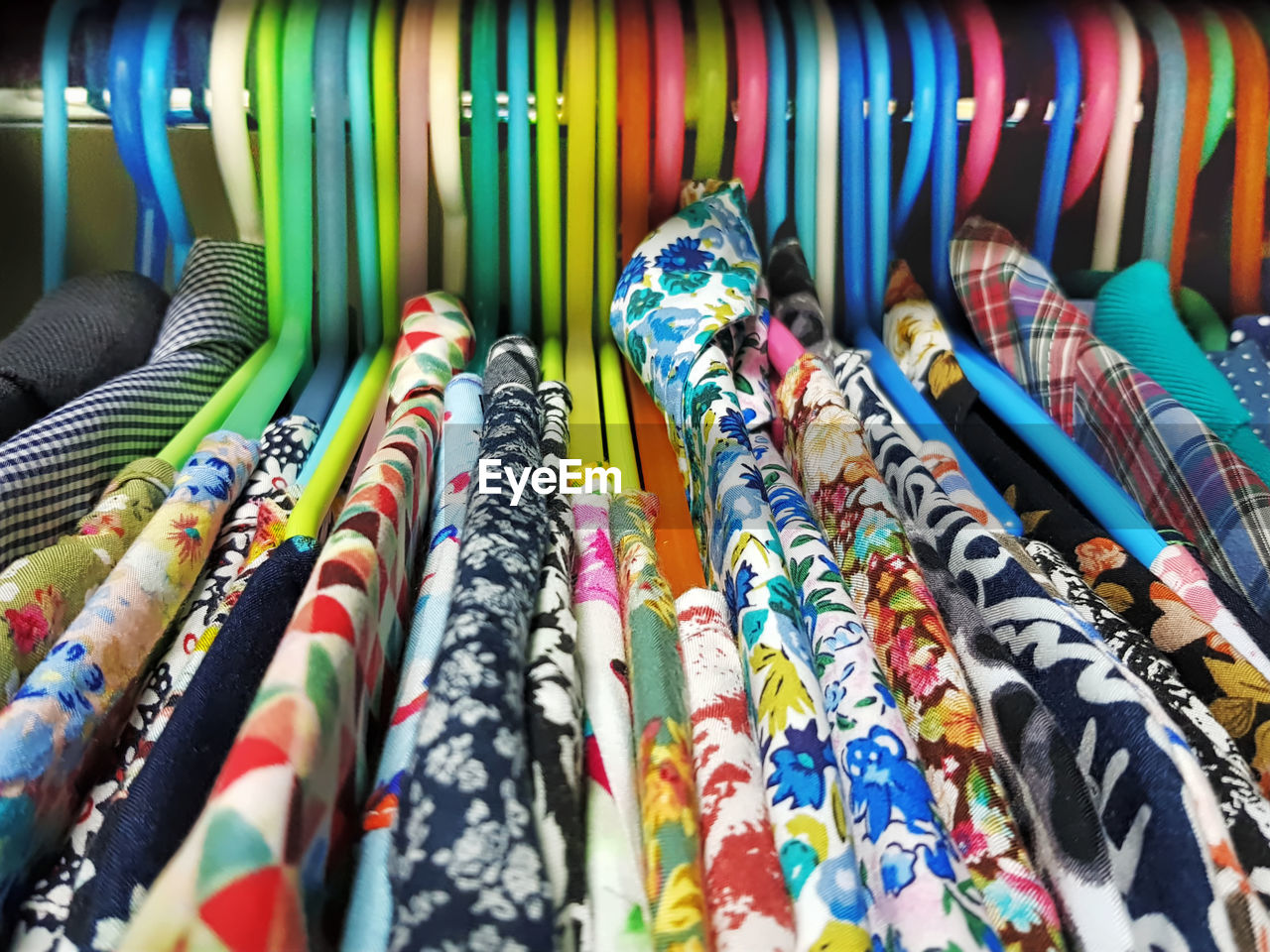 Close-up of multi colored clothes on rack in store