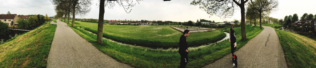 PANORAMIC SHOT OF GREEN FIELD AGAINST SKY