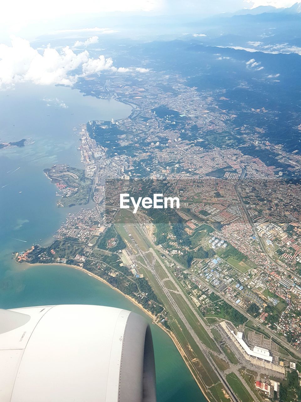 AERIAL VIEW OF CITYSCAPE WITH SEA IN BACKGROUND