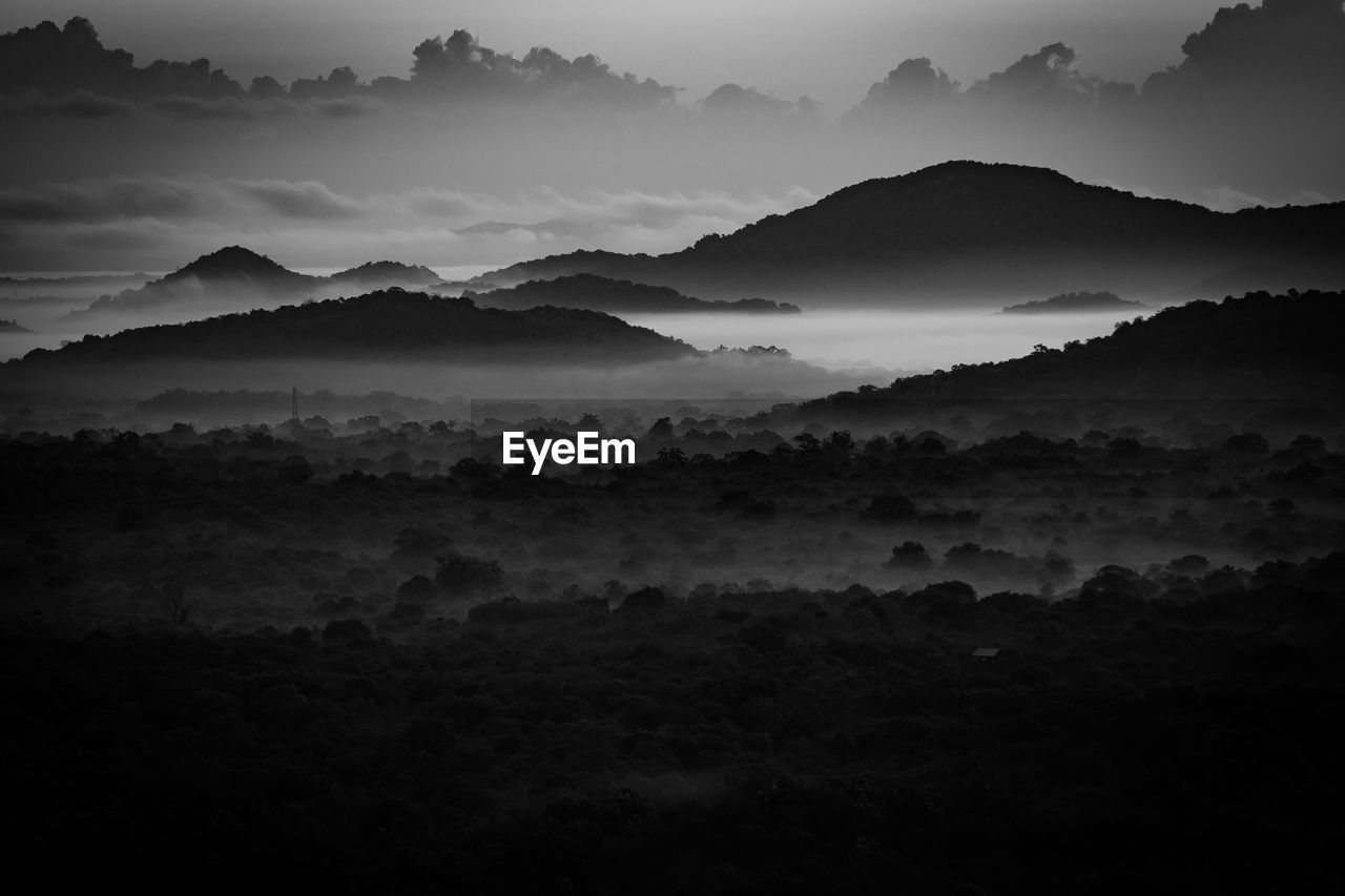 Scenic view of mountains against storm clouds