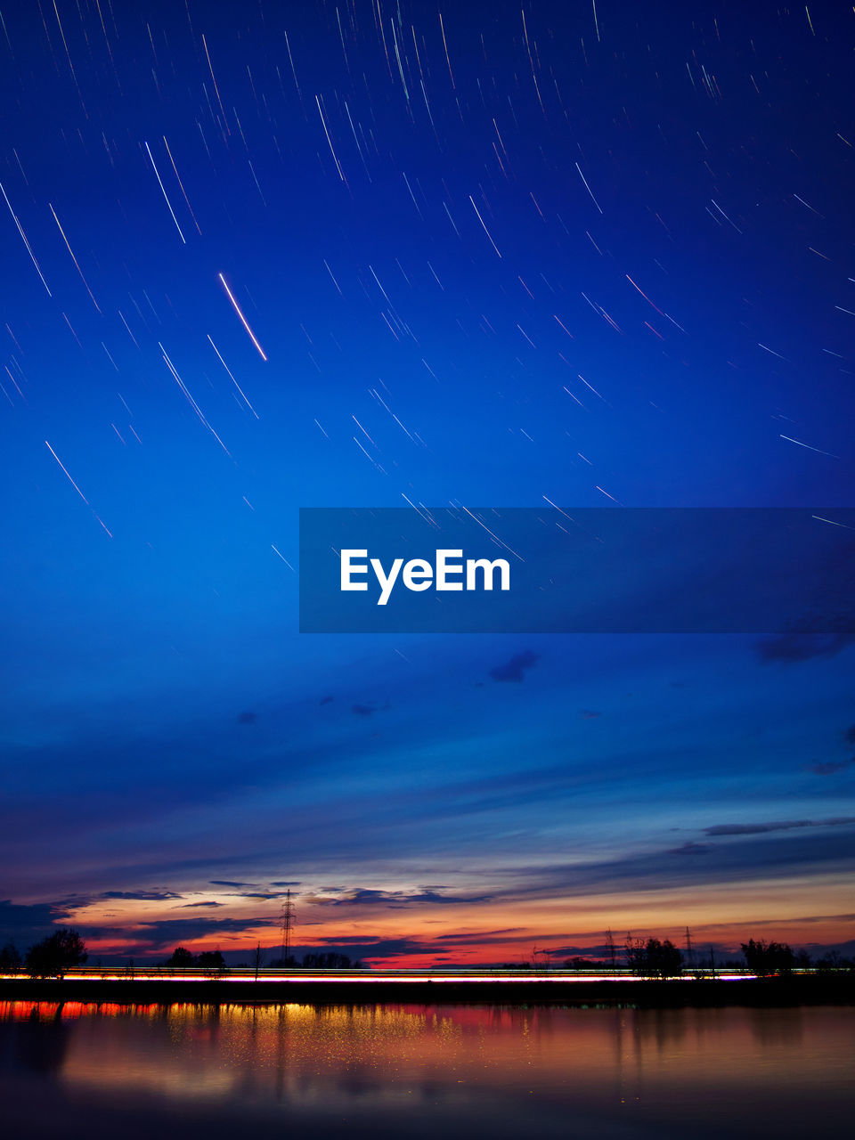 Scenic view of lake against star trails