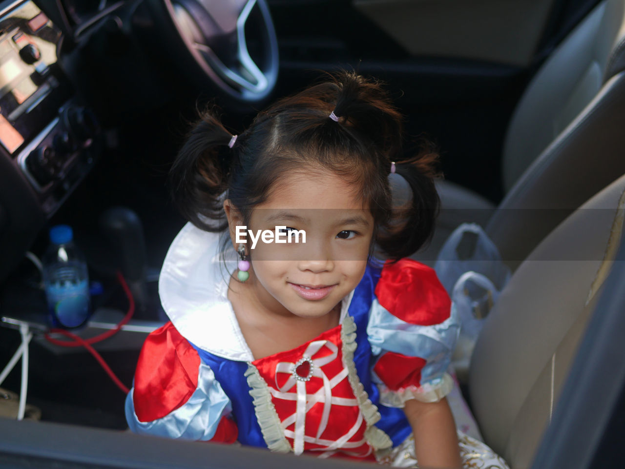 Portrait of girl sitting in car