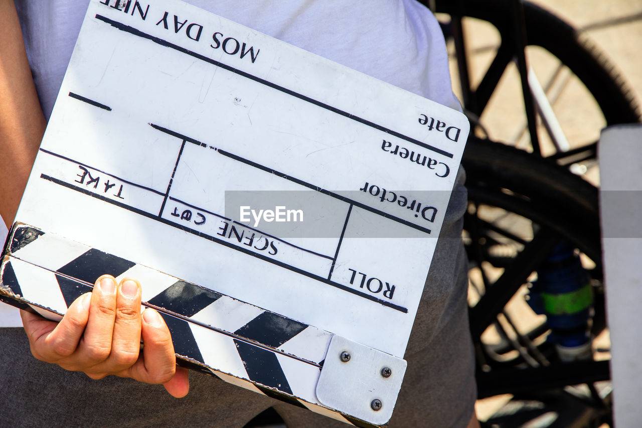 Close up image of film production crew holding film slate on set