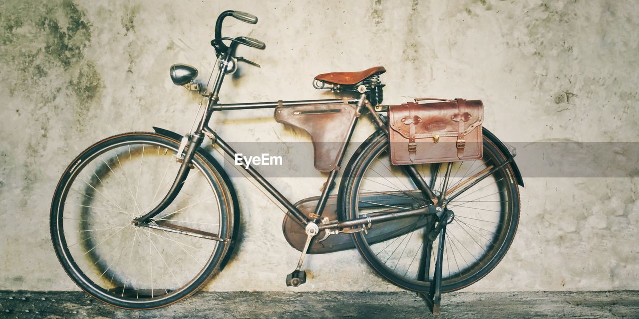 BICYCLES LEANING ON WALL