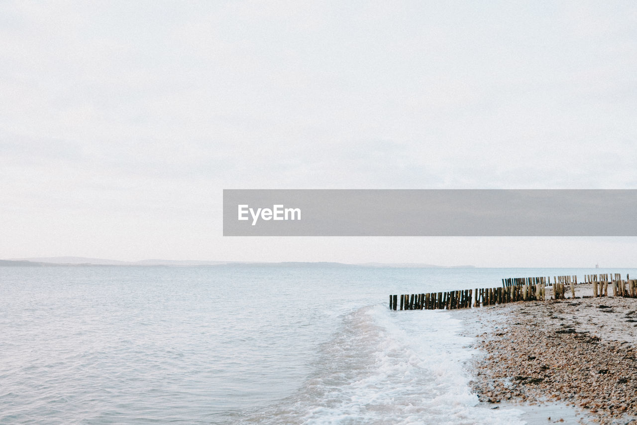 scenic view of beach against clear sky