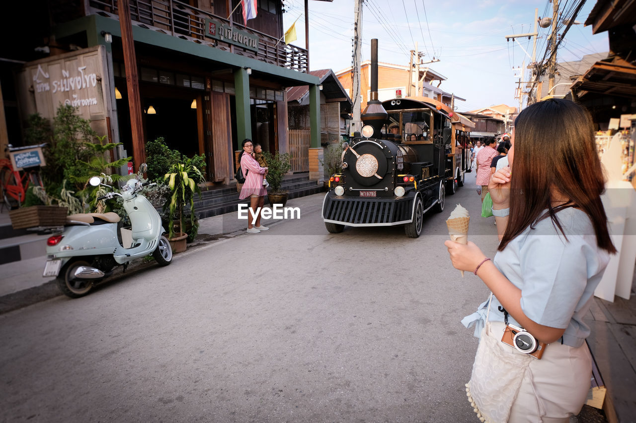 PEOPLE ON STREET IN CITY