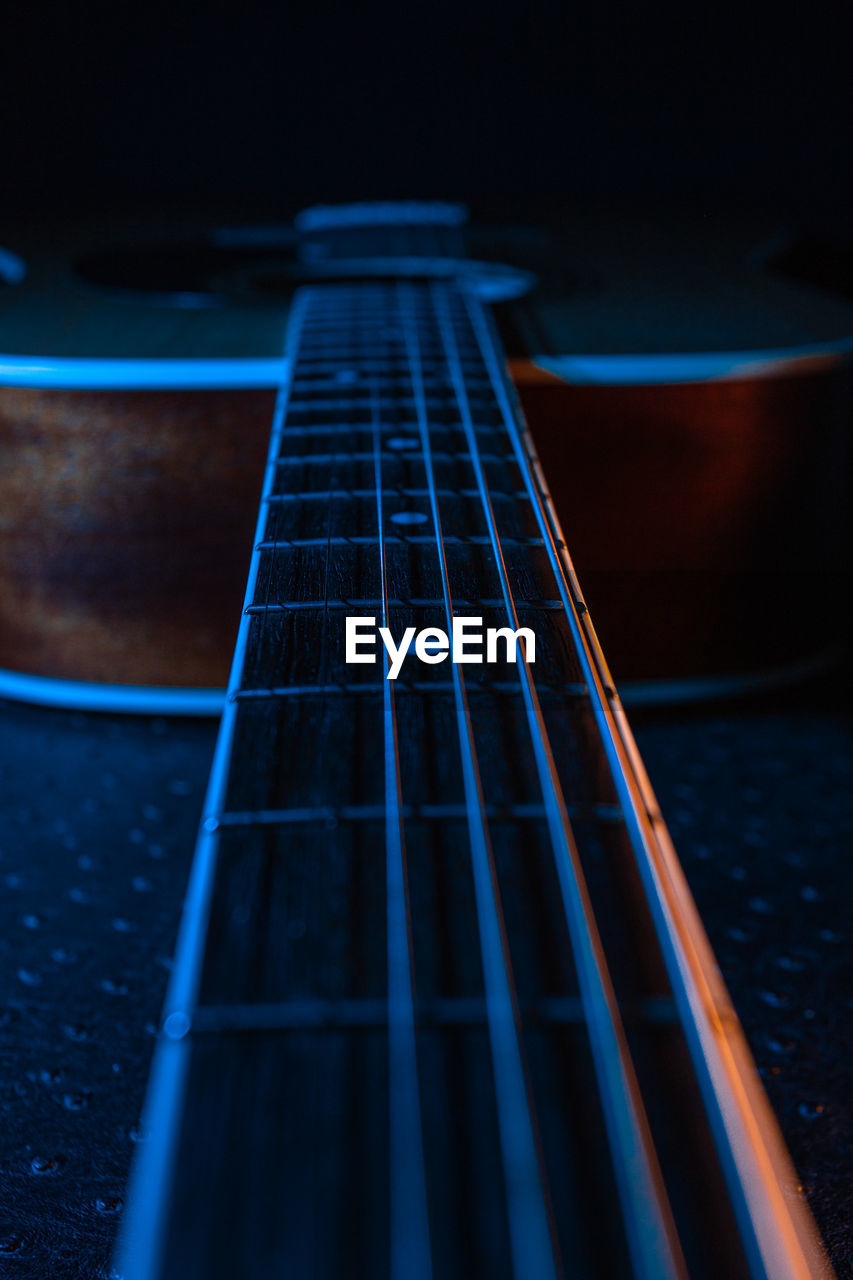 Guitar on a black background.  strings