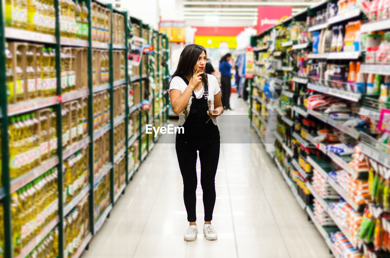 Full length of woman shopping in supermarket