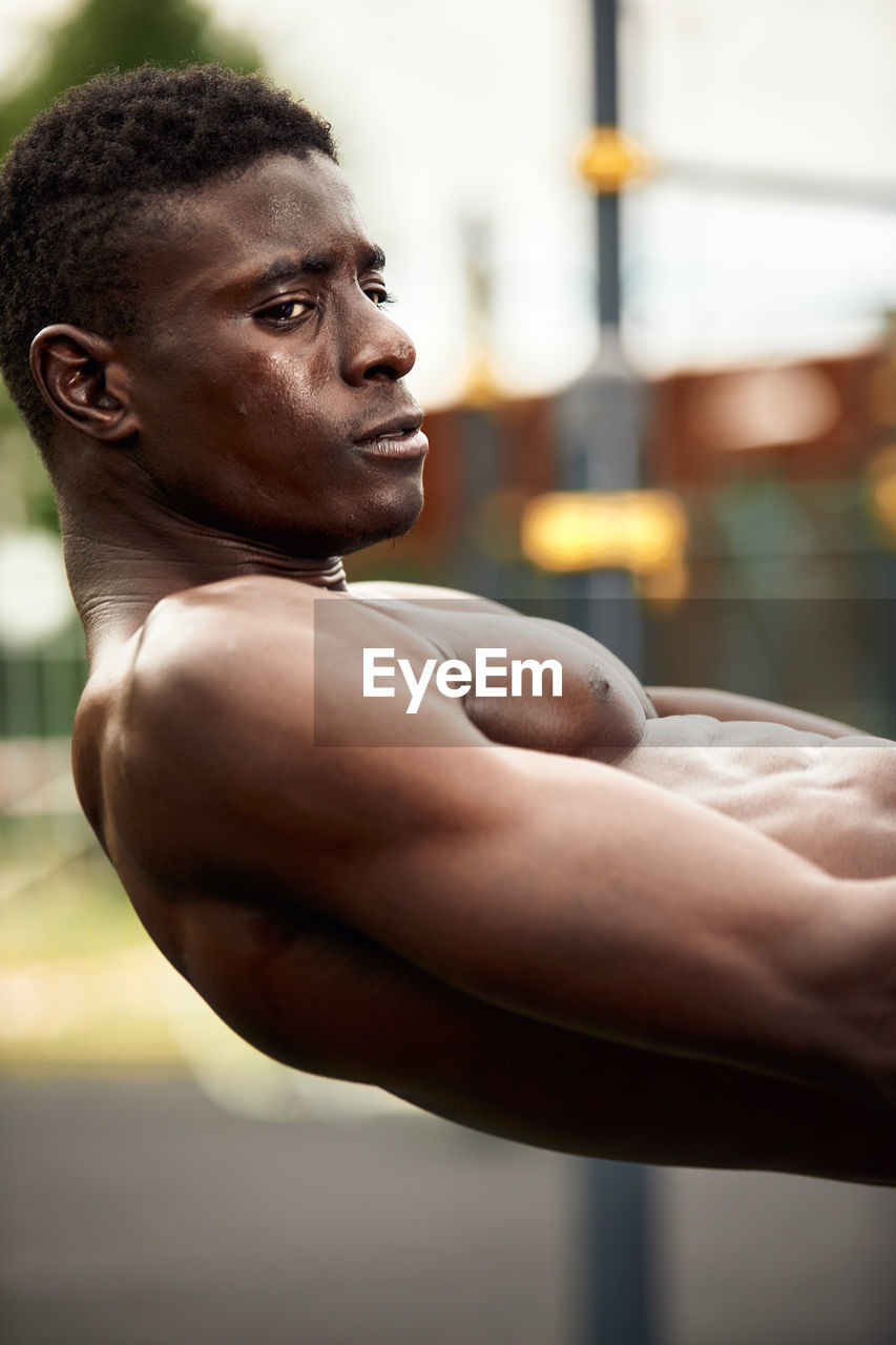 side view of young man exercising in gym