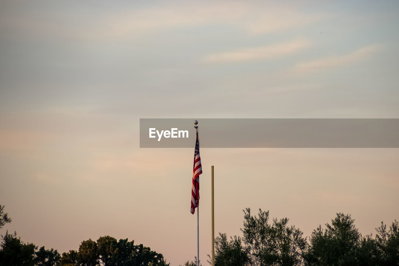 LOW ANGLE VIEW OF SILHOUETTE FLAG AGAINST SKY DURING SUNSET