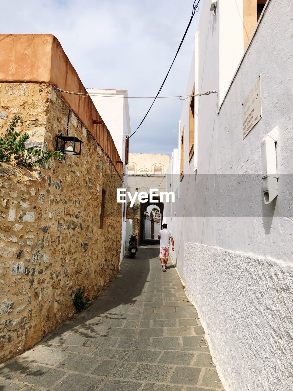 NARROW STREET AMIDST BUILDINGS IN TOWN