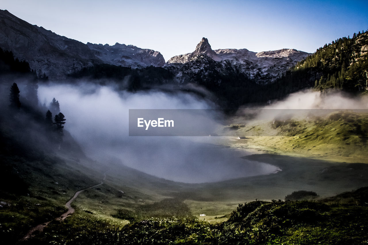 Scenic view of berchtesgaden alps against sky in foggy weather