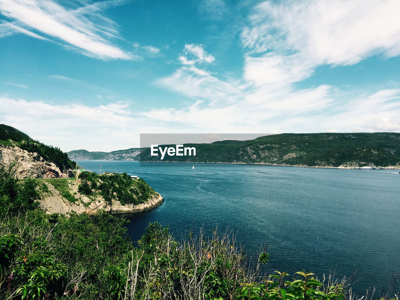 Scenic view of fjord against the sky on a summer sunny day. 