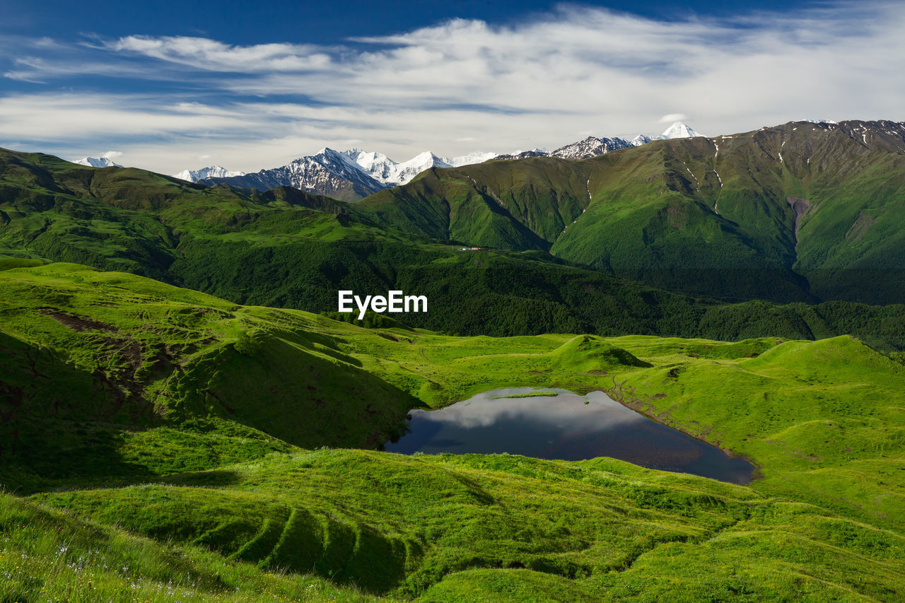 Lake in the mountains of chechnya. scenic view of landscape and mountains against sky