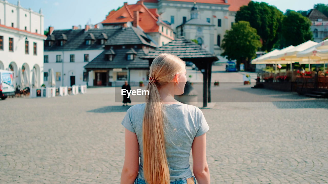 portrait of young woman walking on street