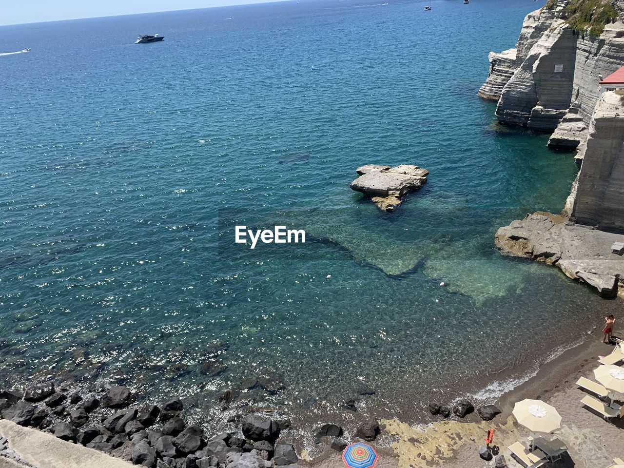 HIGH ANGLE VIEW OF ROCKS BY SEA