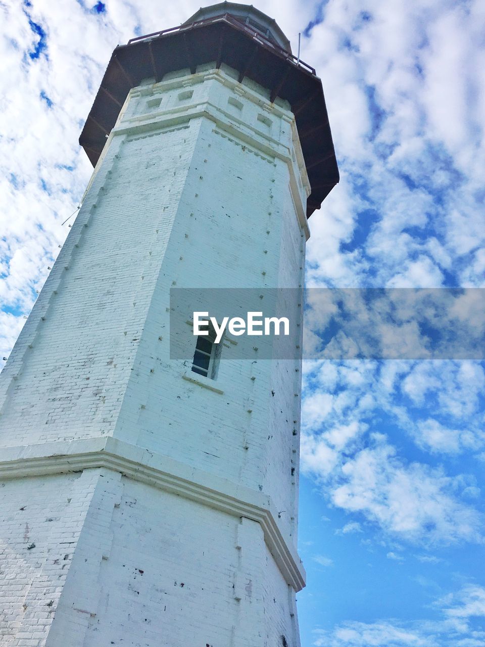 LOW ANGLE VIEW OF TOWER AGAINST CLOUDY SKY