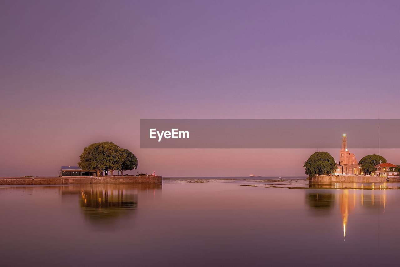 Scenic view of lake against sky during sunset