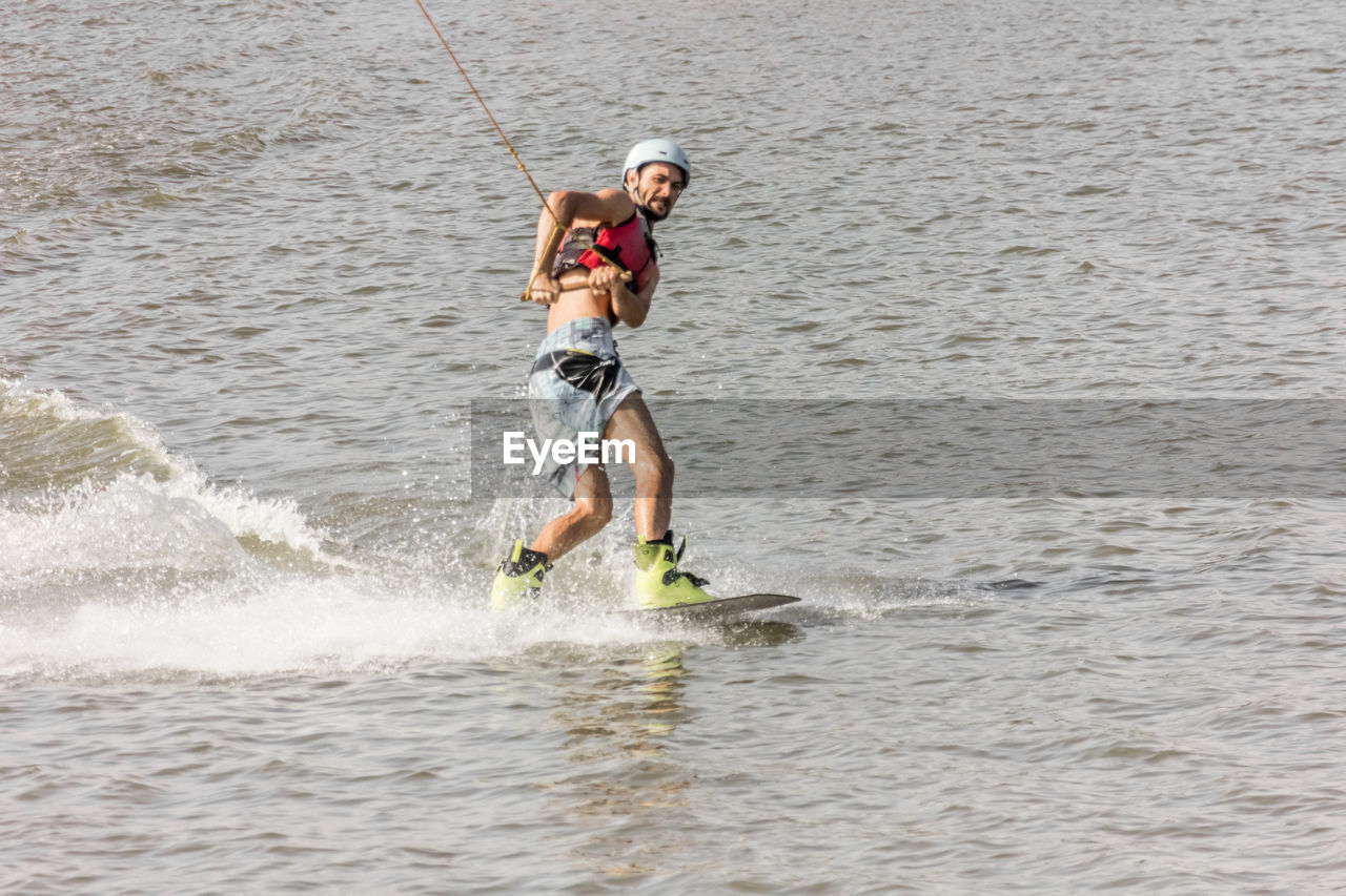 Man kite boarding in river