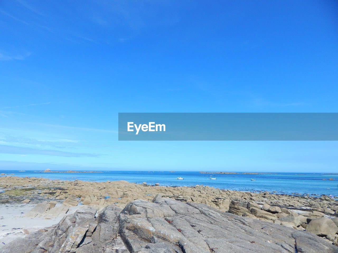 Scenic view of seascape against blue sky