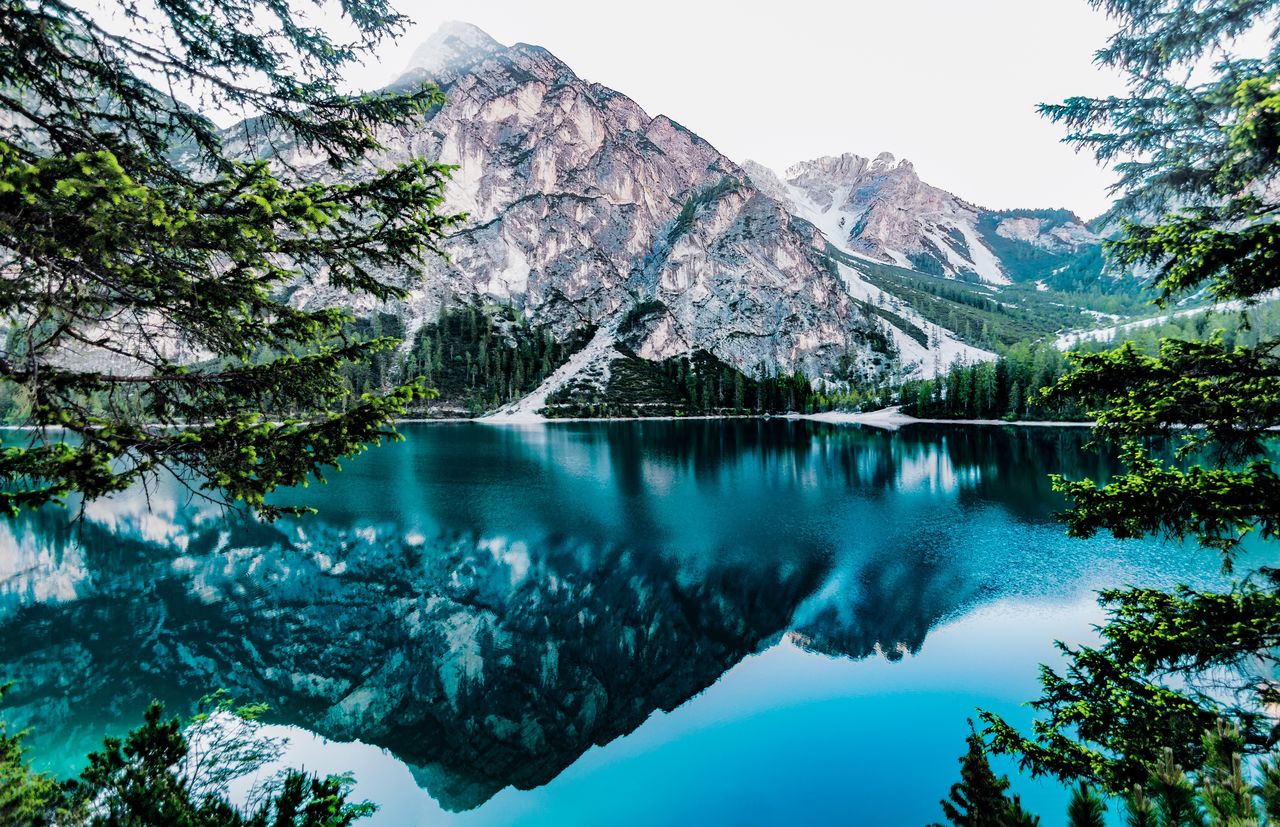 Scenic view of lake and mountains against sky