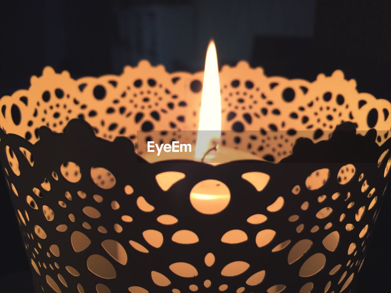 CLOSE-UP OF ILLUMINATED CANDLES