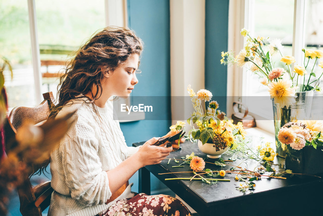 side view of young woman using mobile phone