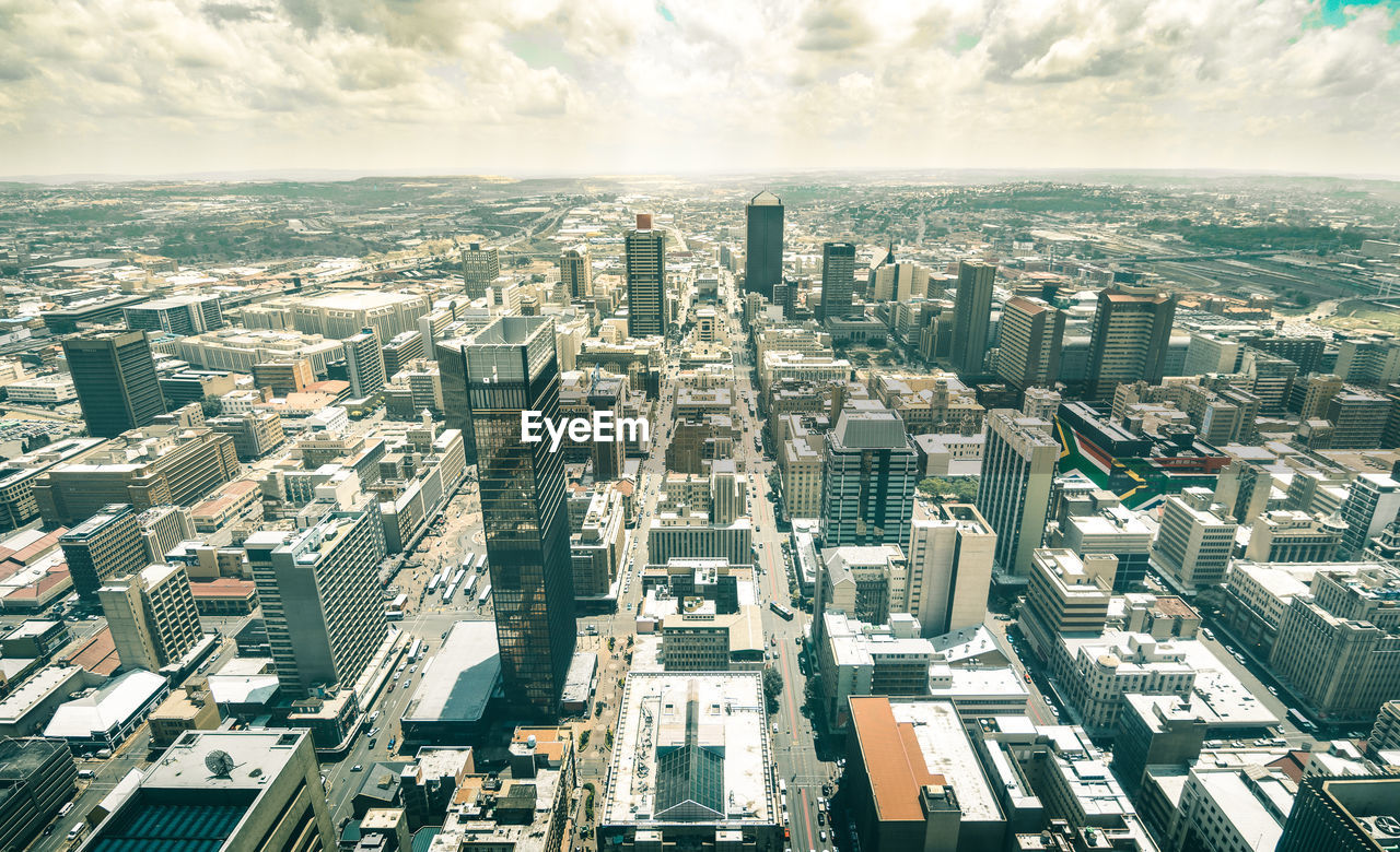 High angle view of modern buildings in city against sky