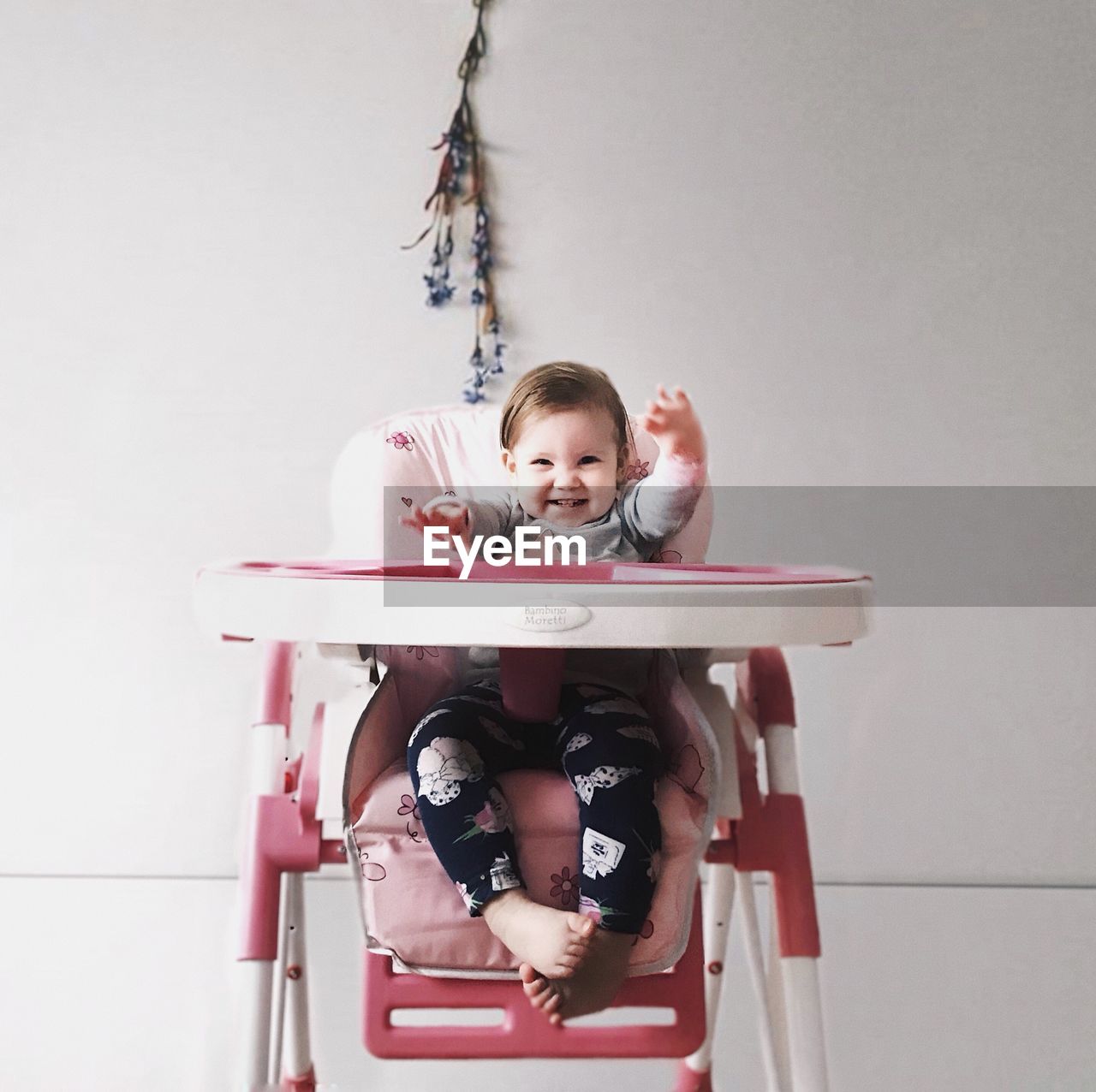 PORTRAIT OF BOY SITTING ON TOY