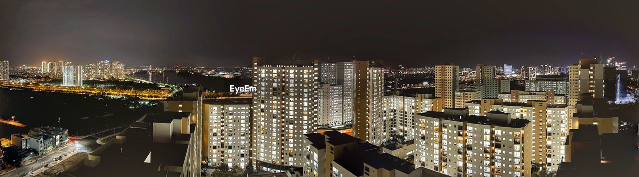 High angle view of illuminated city buildings at night