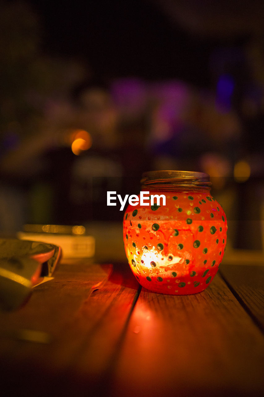 CLOSE-UP OF LANTERN ON TABLE