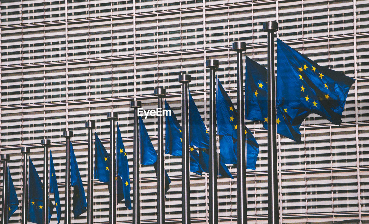 Low angle view of european union flags against modern building