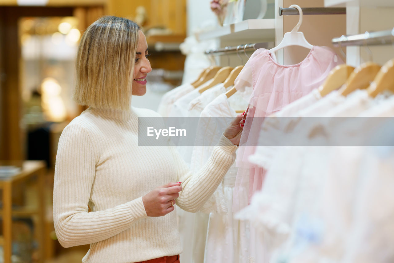 rear view of woman standing against store