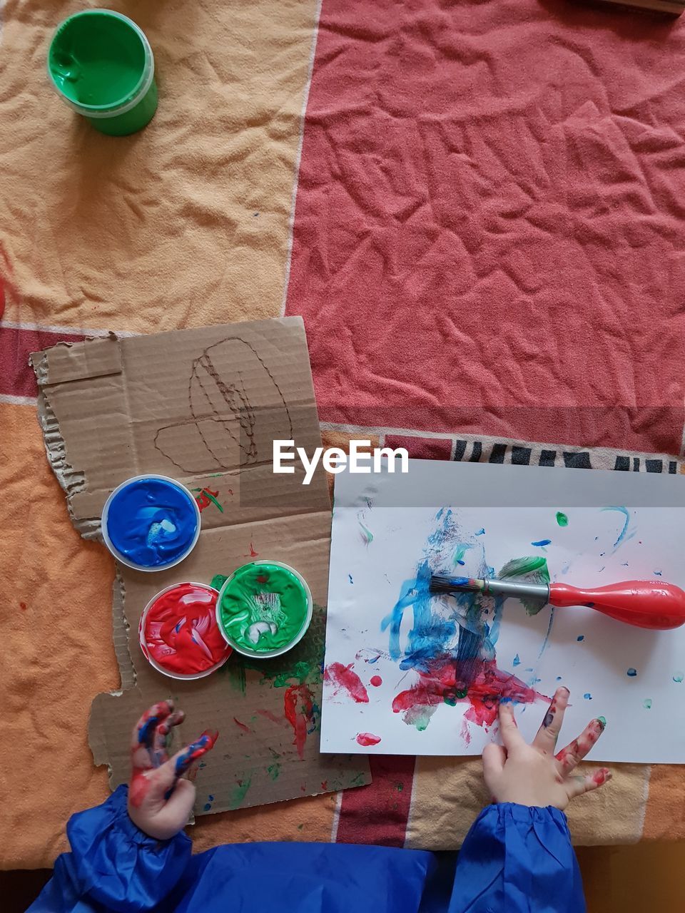 Cropped hand of child drawing at table