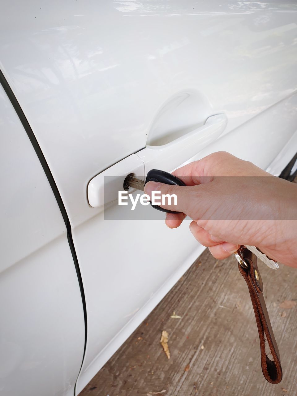 Cropped hand opening car with key