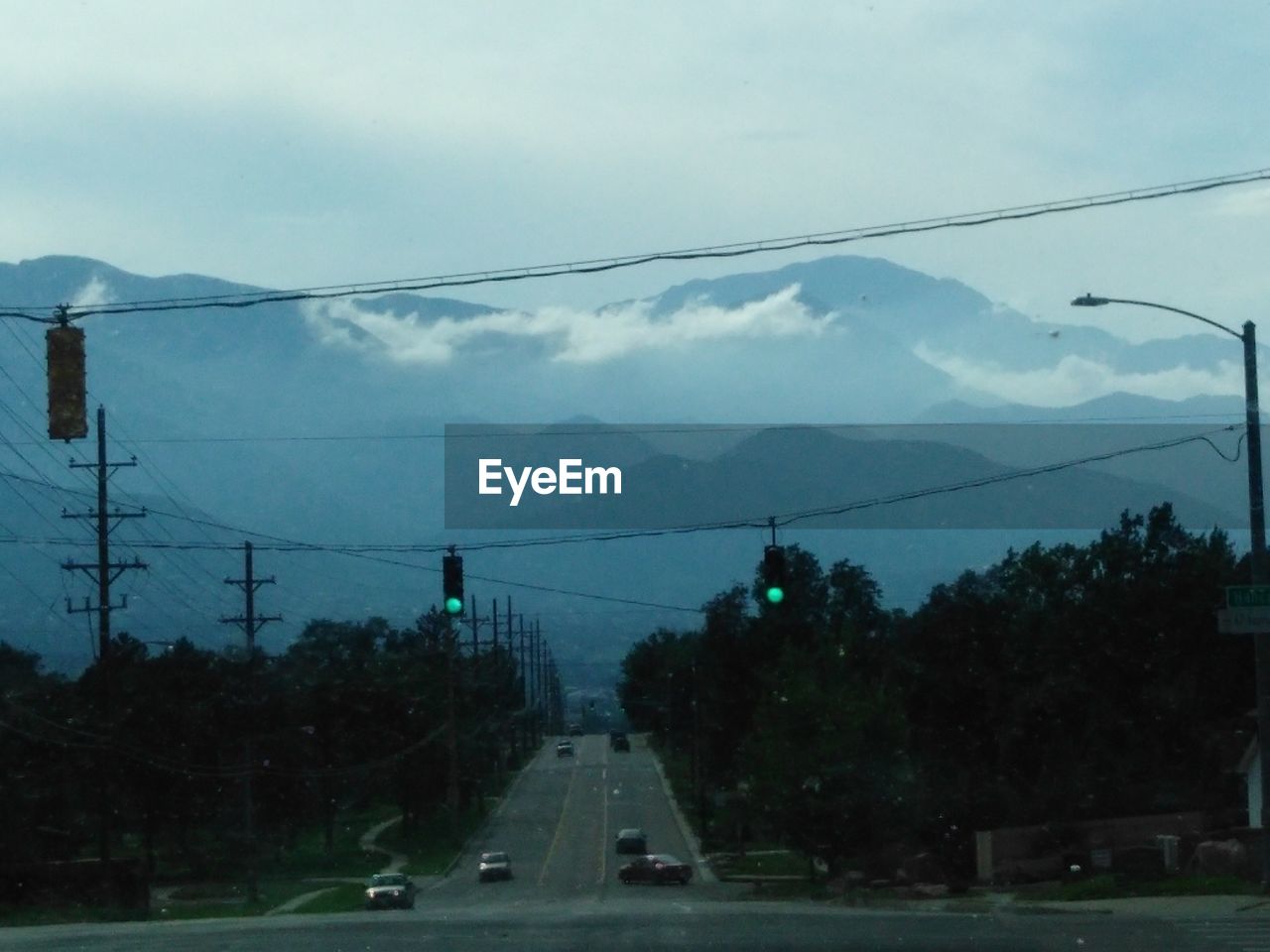 VEHICLES ON ROAD AGAINST SKY