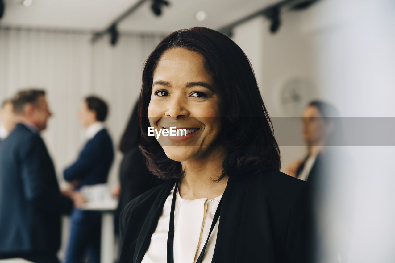 Portrait of smiling businesswoman at office seminar